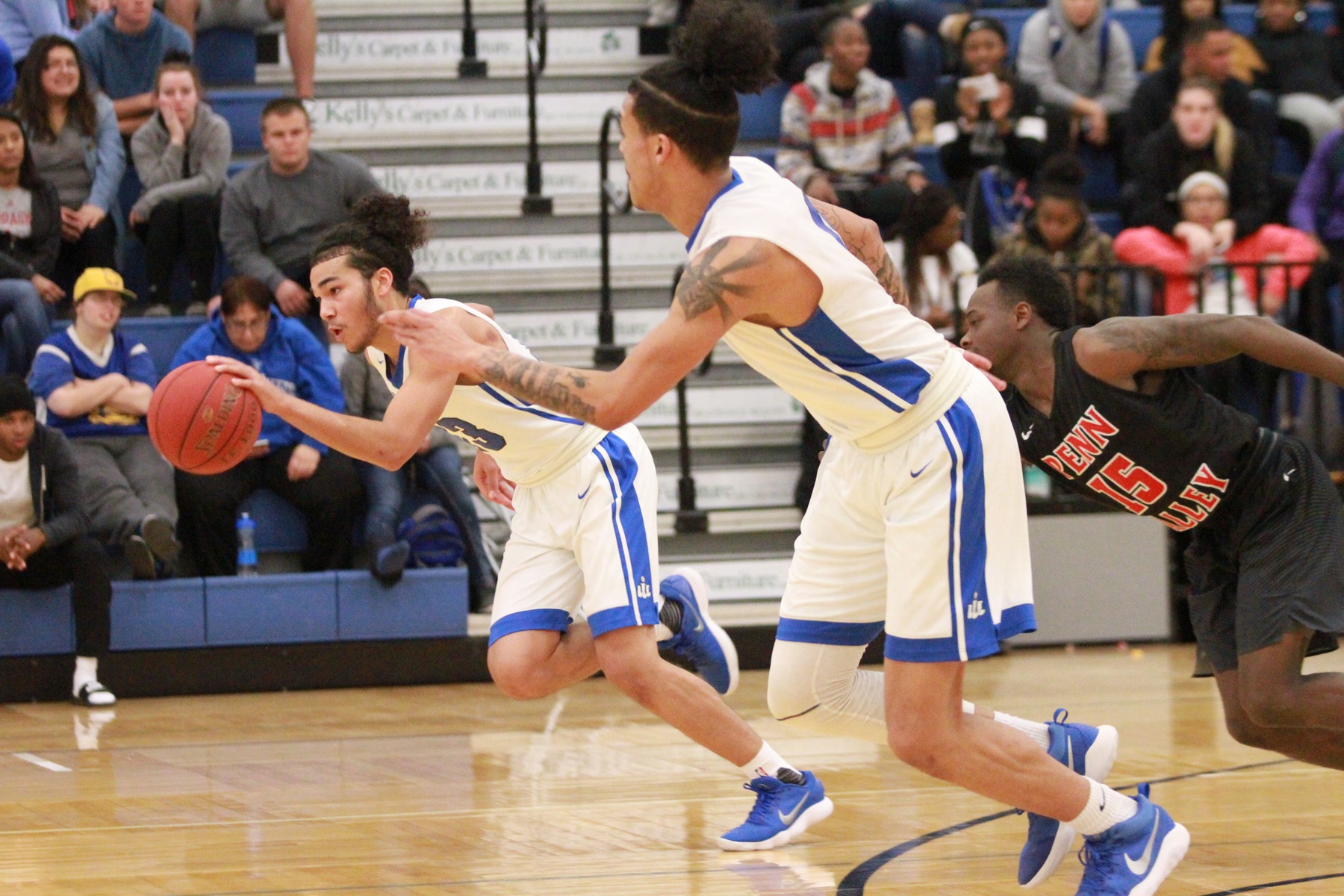 The duo of Pat Dembley (with ball) and Isaiah Wade (on right) combined for 43 of the Reivers 86 points Tuesday night (11/28). Wade also grabbed a team high 13 rebounds in the Reivers' 86-83 victory over Penn Valley.