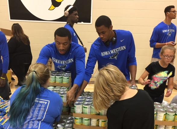 Left to Right: Freshmen Willard Anderson, Seneca Louis, Marques Watson, and Andre Silva were among the Men's Basketball Team that helped with the Council Bluffs Food Pantry Giveaway Monday evening (9/17/18).