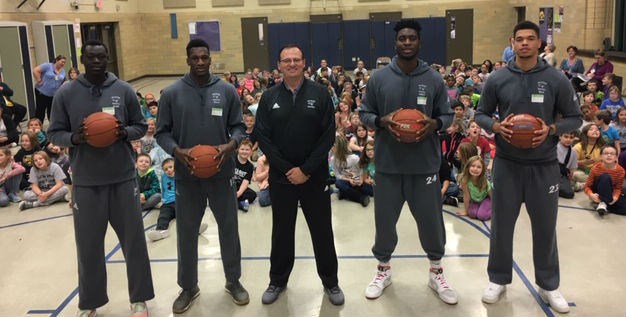 From Left to Right: Esahia Nyiwe, Amadou Sylla, Head Coach Michael Johnette, Emmanuel Ugboh, and Andre Silva encouraged and entertained the youth at Hoover Elementary as part of the "Slam Dunk Attendance Day".